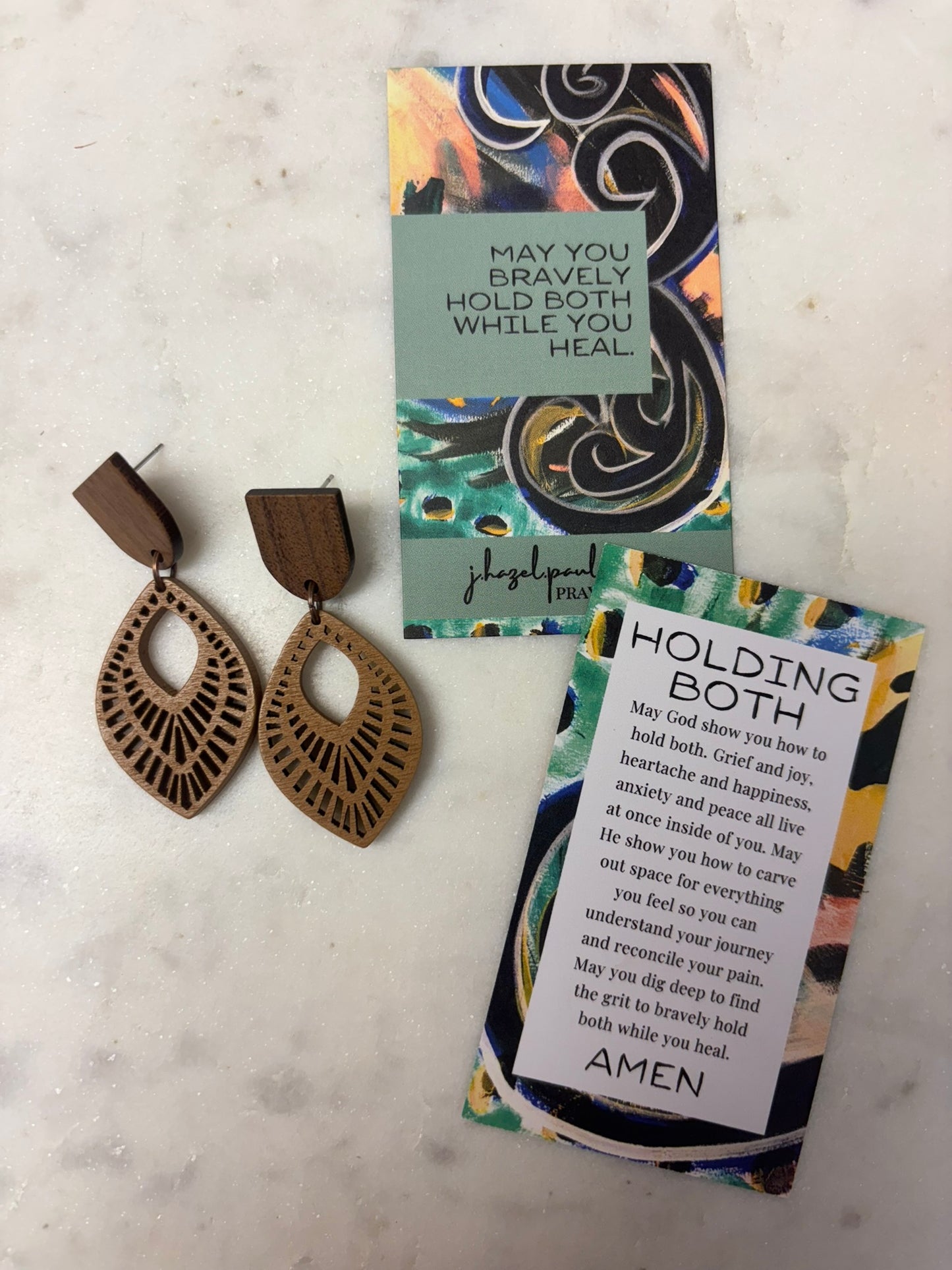 Holding Both Earrings